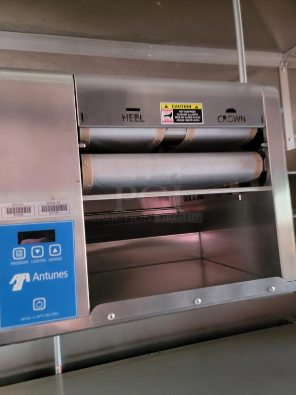 Antunes commercial toaster, stainless steel, features include heel and crown settings, caution label, programmable controls.