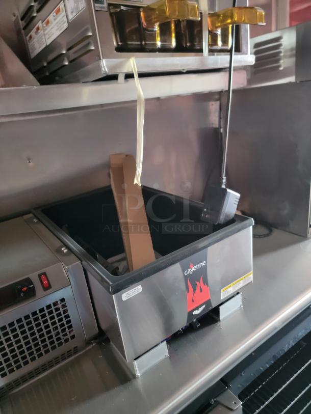 Cayenne food warmer with visible branding, stainless steel, used condition, equipped with control panel, power indicators, and serving pans.