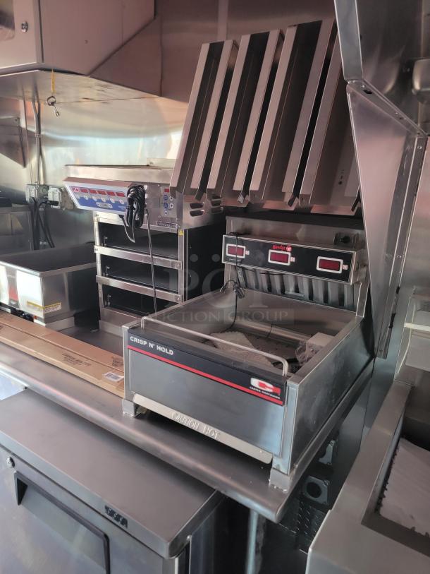 Commercial kitchen equipment featuring a Crisp N' Hold unit, stainless steel design, Wendy's labels, in excellent condition.