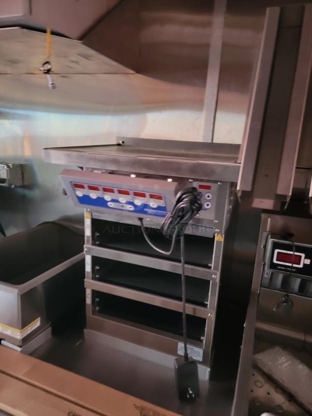 Commercial stainless steel food warming drawer unit with control panel and multiple shelves. Excellent condition.