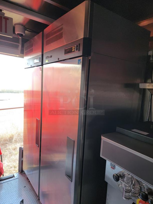 Stainless steel commercial refrigerator with digital controls and ventilation panels, in excellent condition.