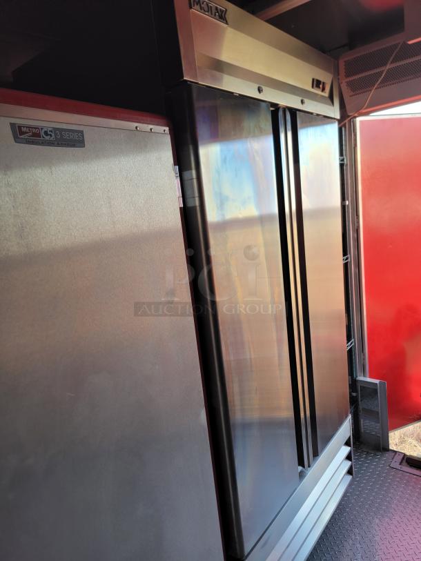 Commercial refrigerator, stainless steel, double doors, Motak brand. Visible Metro C5 3 Series label, excellent condition.