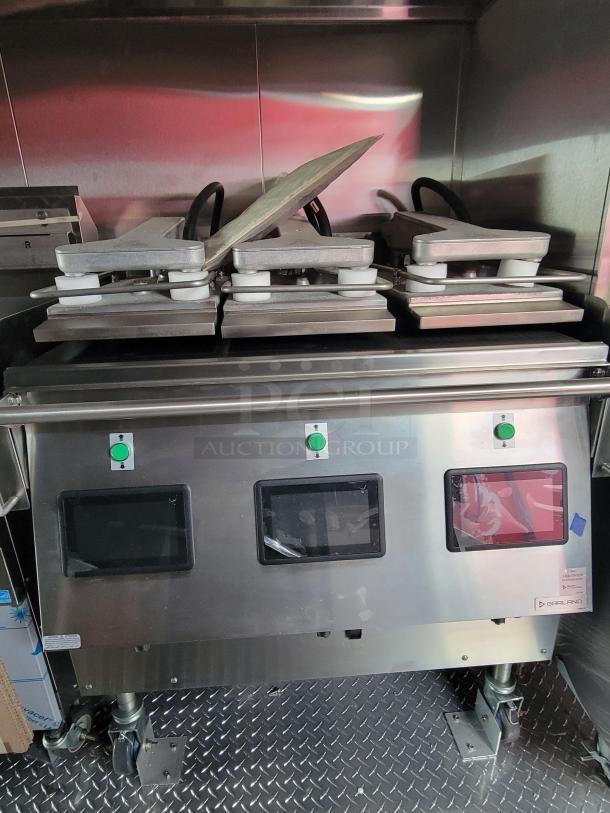 Commercial Garland grill with clamshell press, stainless steel, dual digital displays, in good condition, on caster wheels.
