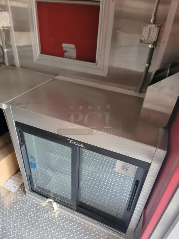 True commercial refrigerator with sliding glass doors, stainless steel finish, excellent condition, visible QR code.