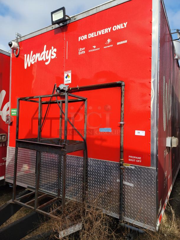 Red Wendy's delivery truck with metal diamond plating, logos for delivery apps, and propane shut-off label.