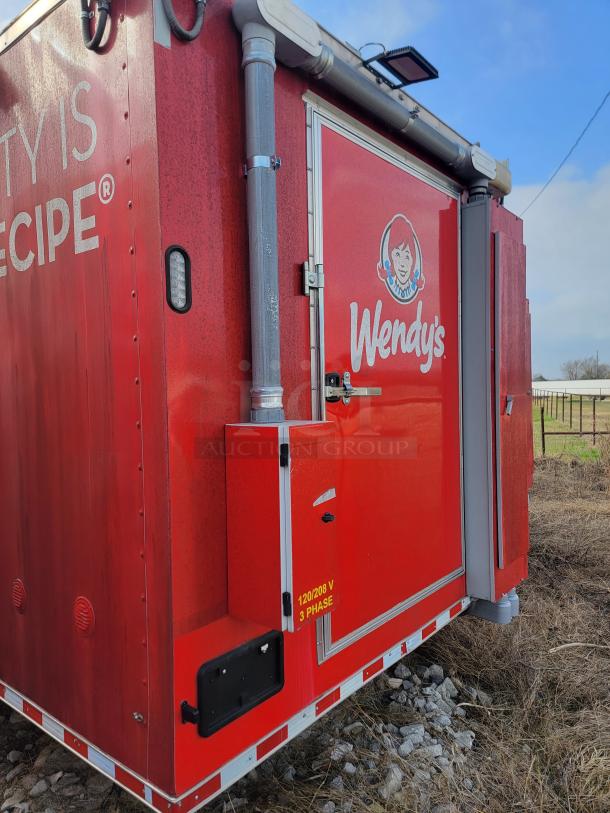 Wendy's branded mobile unit, red exterior, featuring a door and utility panel. Marking indicates 120/208V, 3 phase.