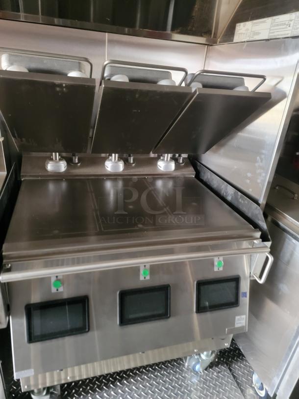 Commercial stainless steel griddle with three sections, control knobs, and digital displays, in excellent condition.