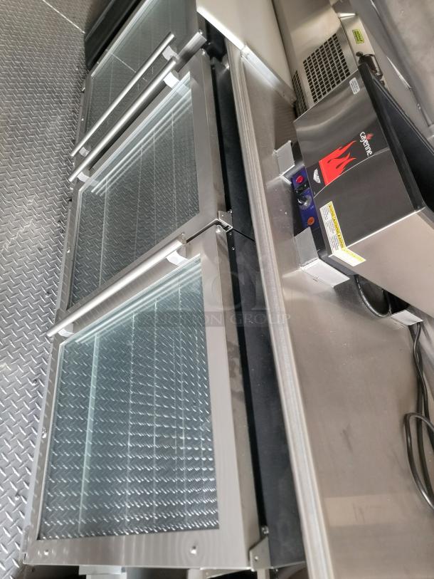 Stainless steel counter with glass-front cooler drawers and a Hatco Cayenne food warmer unit. Excellent condition.