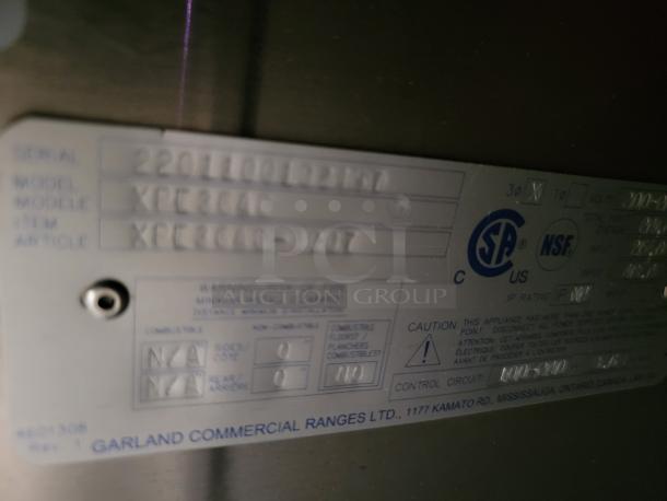 Garland Commercial Range model XPE36AC label showing serial 220110012167, CSA and NSF certifications, and safety warnings.