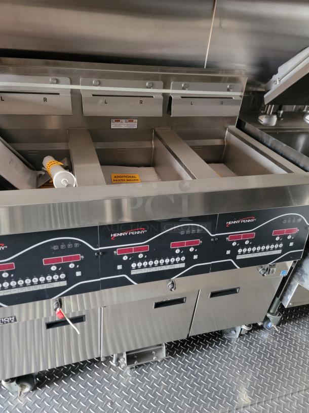 Henny Penny commercial fryer with digital controls, two main compartments, labeled "L" and "R," in stainless steel.