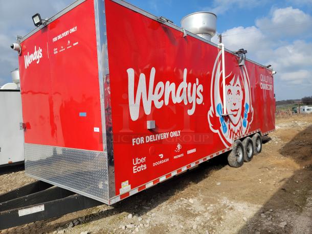 Red Wendy's food trailer with delivery service logos, triple-axle, ventilation system, "For Delivery Only" text.