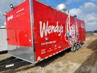 Red Wendy's food trailer with delivery service logos, triple-axle, ventilation system, "For Delivery Only" text.