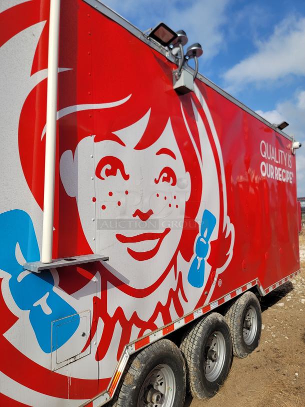 Red food trailer featuring a large Wendy's logo and the slogan "Quality is Our Recipe" on the side. Triple axle design.