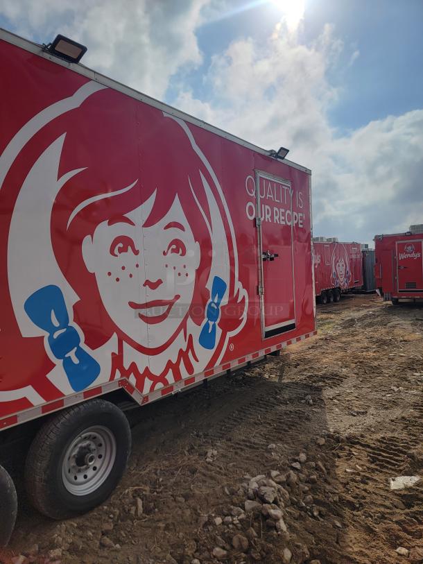 Red Wendy's food trailer with logo and "Quality is Our Recipe" text, parked on dirt ground. Appears in good condition.