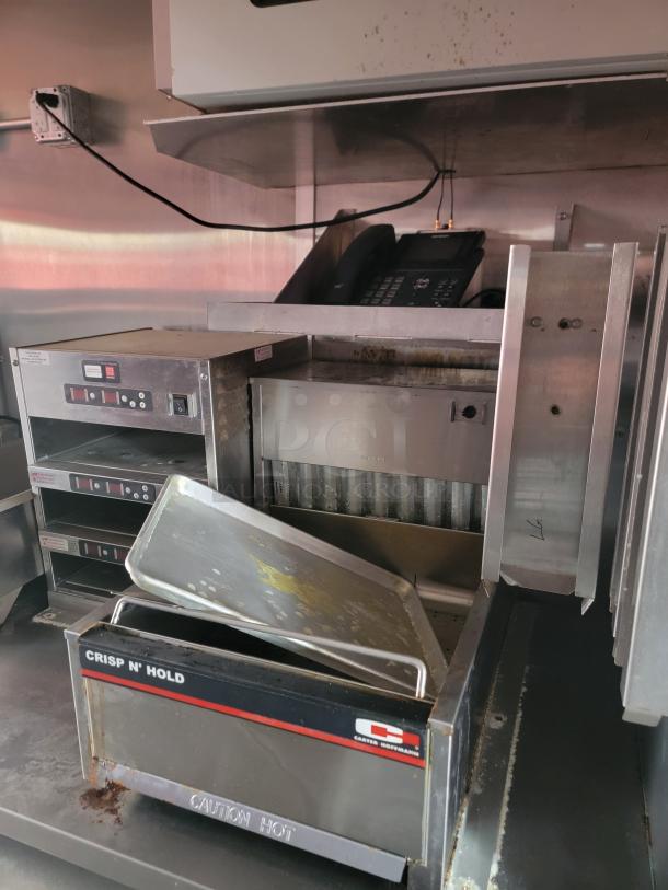 Carter Hoffmann Crisp N’ Hold food warmer, used condition, features multiple compartments, visible "Caution Hot" label.