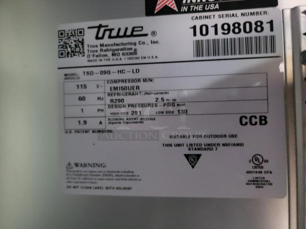 Close-up of a label on a True Manufacturing Co. refrigeration unit, model TSD-09G-HC-LD. Serial number 10198081, using R290 refrigerant.