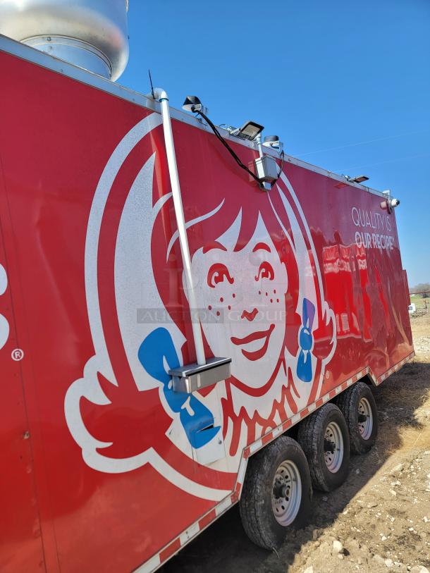 Red mobile food trailer featuring a large Wendy's logo, three axles, and roof equipment visible; slogan "Quality is Our Recipe."