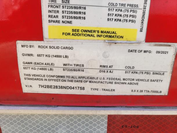 Trailer data plate showing manufacturer Rock Solid Cargo, GVWR 6577 kg, GAWR 6577 kg, tire size ST235/80R16, manufactured 09/2021.