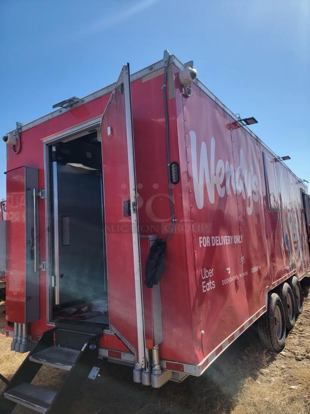 Red Wendy's delivery trailer with side door open, featuring Uber Eats and DoorDash logos. In fair condition.