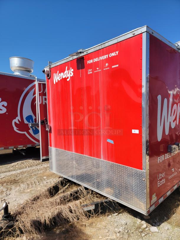 Red Wendy's delivery trailer with visible logos for Uber Eats, DoorDash, and Grubhub. Diamond plate panels on the lower side.