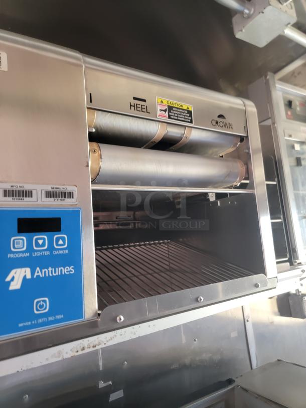 Antunes commercial toaster with labeled sections "HEEL" and "CROWN," digital interface, and caution sticker. Good condition.
