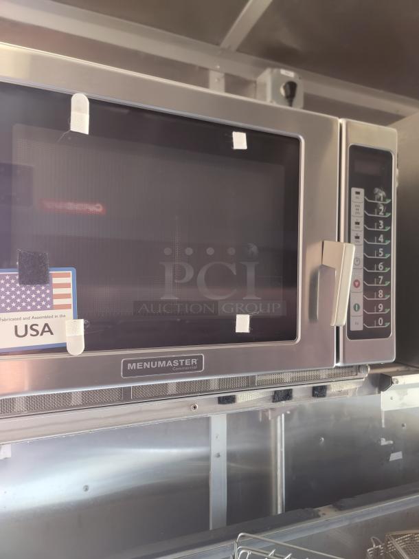 Menumaster commercial microwave with keypad, ventilation panel, and USA fabrication label. Good condition.