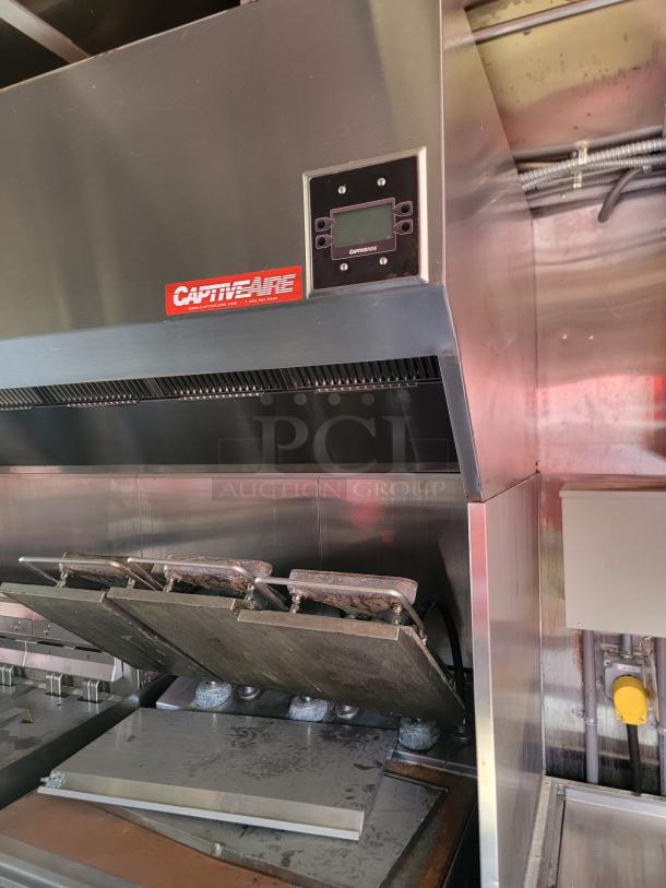 CaptiveAire commercial kitchen hood with control panel, stainless steel, used condition. Red logo and digital display visible.