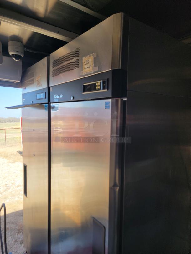 Commercial stainless steel refrigerator, Turbo Air brand, digital display, good condition, with taped labels near top vents.