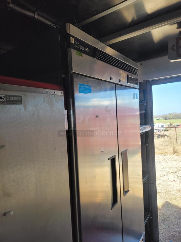 Turbo Air commercial refrigerator, stainless steel, dual doors, digital display, model signage visible, good condition.
