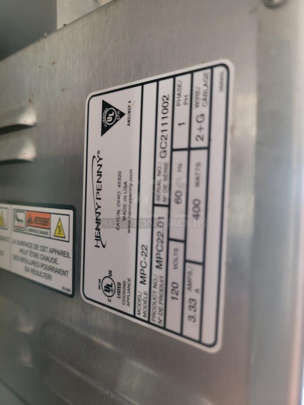Henny Penny MPC-22 appliance tag showing model MPC22.01, 120 volts, serial number GC2111002.