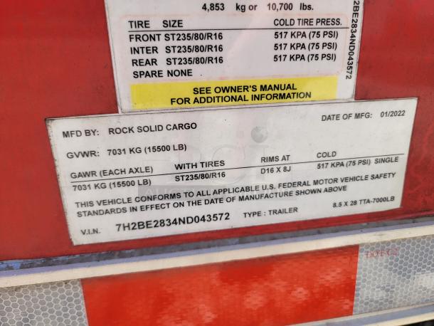 Rock Solid Cargo trailer label showing GVWR 7031 kg, tire specs ST235/80/R16, date of manufacture 01/2022, VIN 7H2BE2834ND043572.