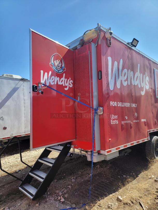 Wendy's delivery-only food truck with logos of Uber Eats, DoorDash, Postmates, and Grubhub; red exterior with entrance steps.