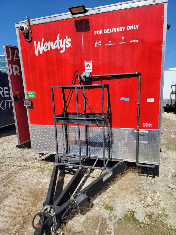 Red Wendy's food delivery trailer with hitch. Features propane system and logos for Uber Eats, DoorDash, Postmates, and Grubhub.