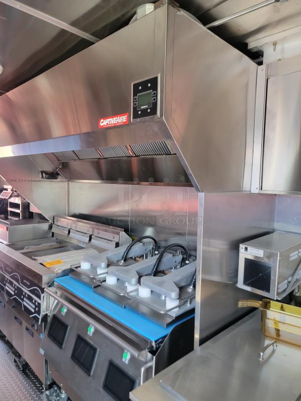 CaptiveAire commercial kitchen hood system with integrated controls, stainless steel construction, new condition.