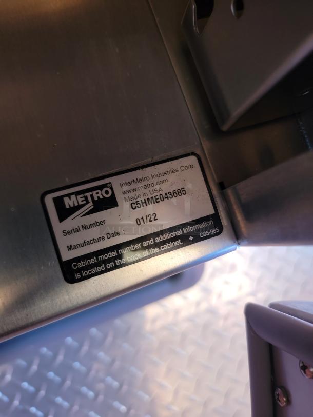 Stainless steel Metro cabinet label, Serial C5HME043685, manufactured 01/22. Made in the USA by InterMetro Industries.