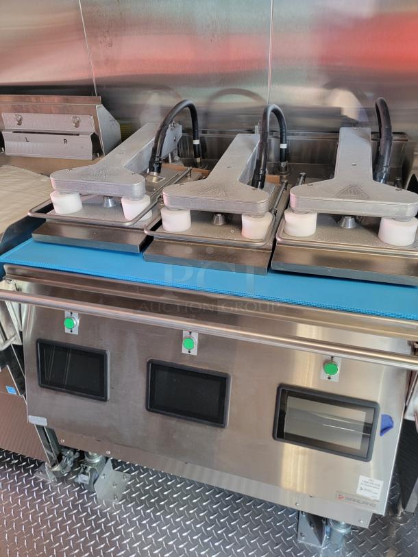 Commercial-grade Garland grill with dual hobs, stainless steel finish, green control buttons, and mounted on non-slip flooring.