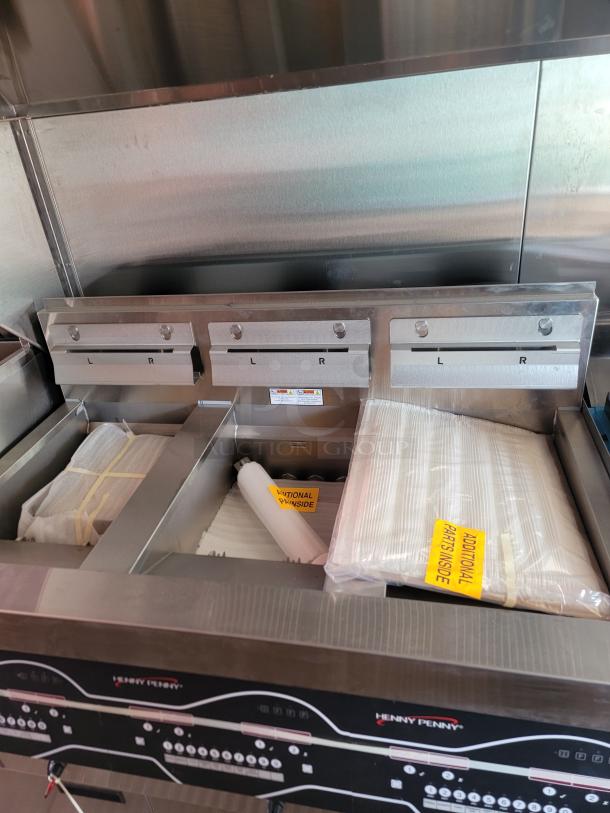 Henny Penny commercial fryer with three-part design, new condition. Includes labeled "Additional Parts Inside" packaging.
