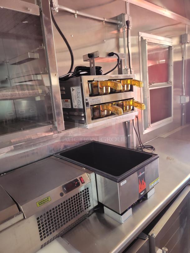 Industrial kitchen equipment, Cave Tools appliance, dual oven with protective covers, stainless steel finish, good condition.