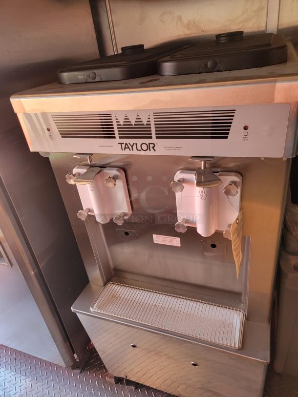 Taylor ice cream machine, stainless steel body, dual dispensers, visible brand label, excellent used condition.