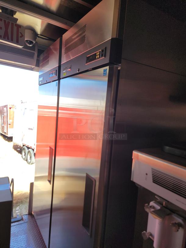 Industrial stainless steel refrigerator with digital controls, dual doors, visible serial number, excellent condition, ideal for commercial use.