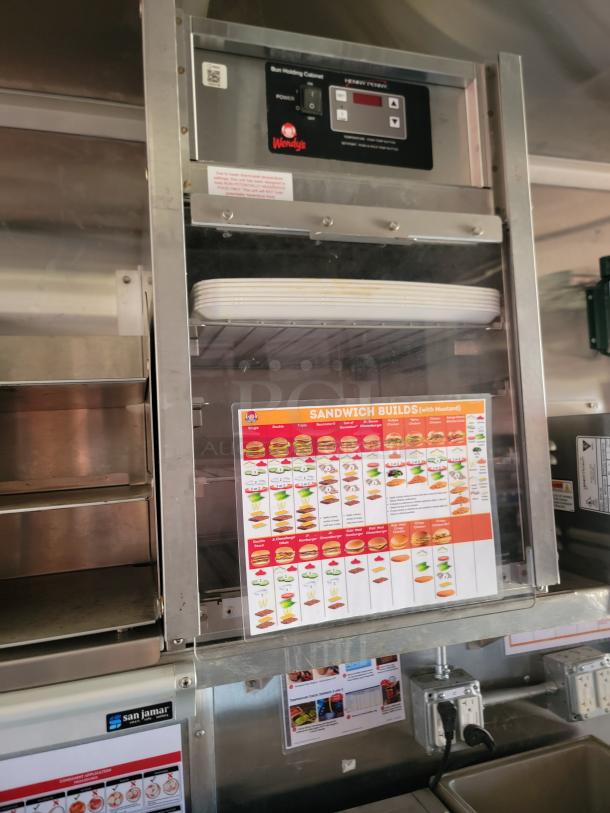 Wendy's bun holding cabinet with digital controls and sandwich builds guide, stainless steel finish, model by Servend.