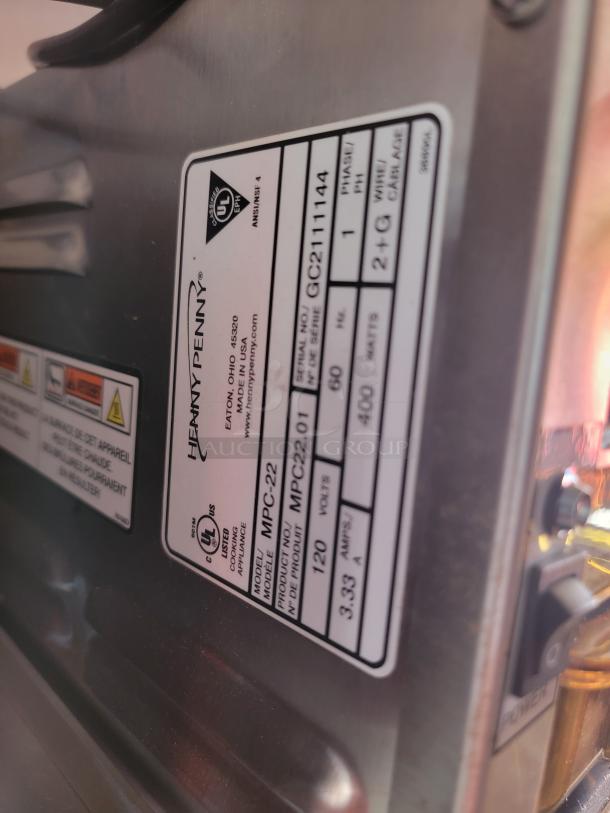 Henny Penny MPC-22 oven label showing serial number GC2111144 and model MPC22.01, 120 volts, phase 1, 400 watts.
