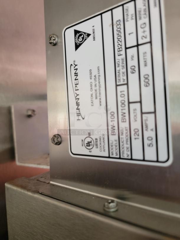 Henny Penny appliance label, model BW-100, serial FB2205033. Made in USA, 120V, 600W. Stainless steel construction.