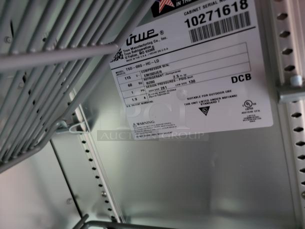 Commercial refrigerator interior with True Manufacturing label showing model TSD-09G-HC-LD, serial 10271618.