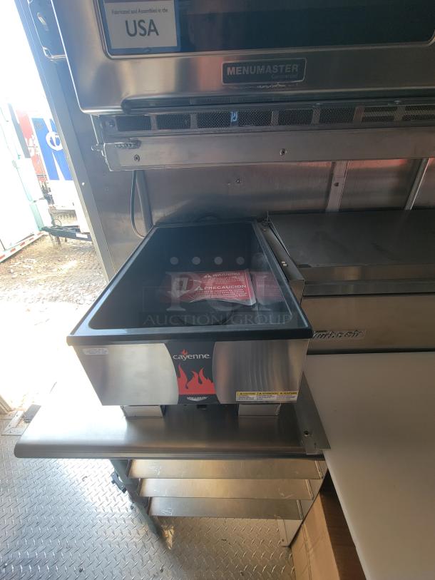 Cayenne warming drawer, stainless steel, Menumaster branding, assembled in USA, with tags and safety warnings visible.