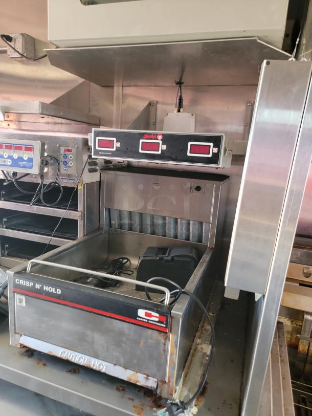 Carter Hoffmann Crisp N' Hold food warmer, visible wear, metal construction, electronic controls labeled "Wendy's," caution markings.
