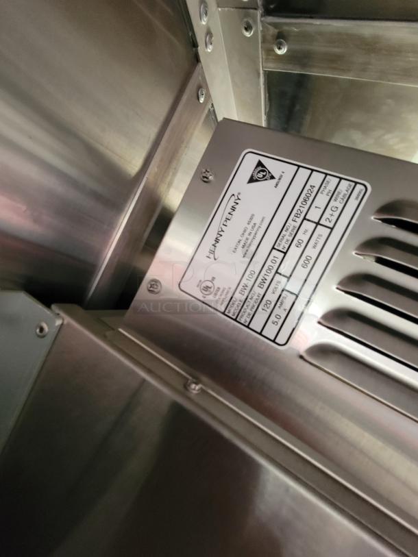 Henny Penny stainless steel equipment label, model FB210602A, 120 volts, 5.0 amps, features inspection tags.