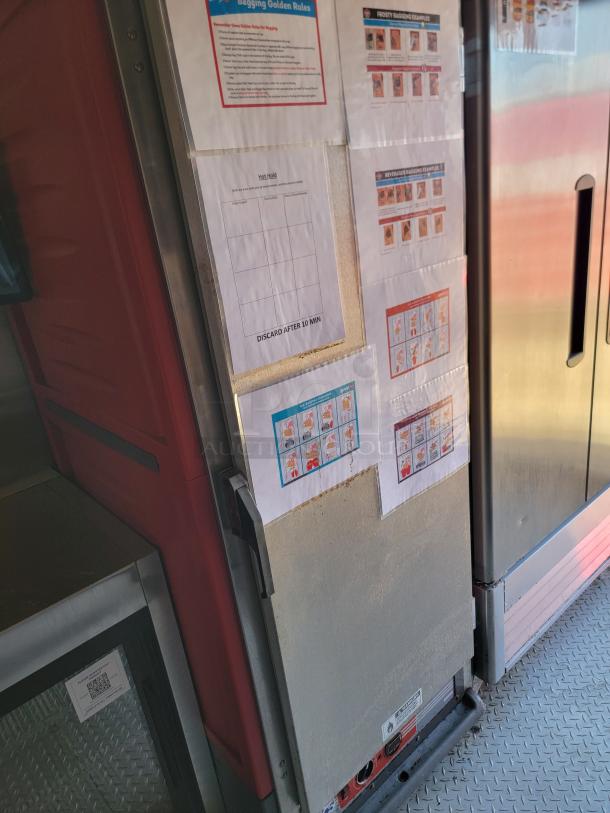 Commercial refrigerator with posted instructions and diagrams, emphasizing organized storage rules and handling procedures.