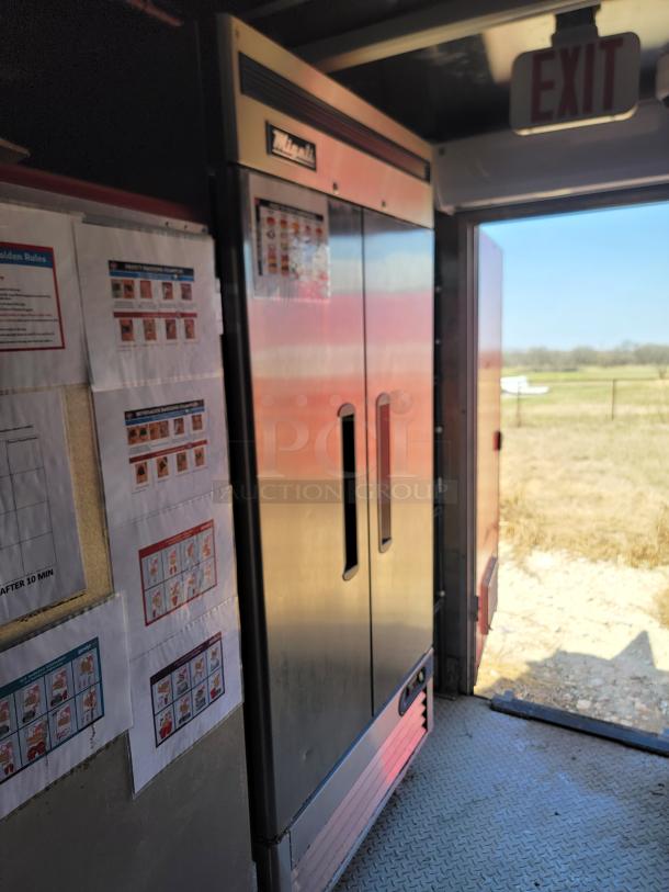 Magikitch'n commercial refrigerator with double doors, stainless steel finish, excellent condition; brand label visible on top.