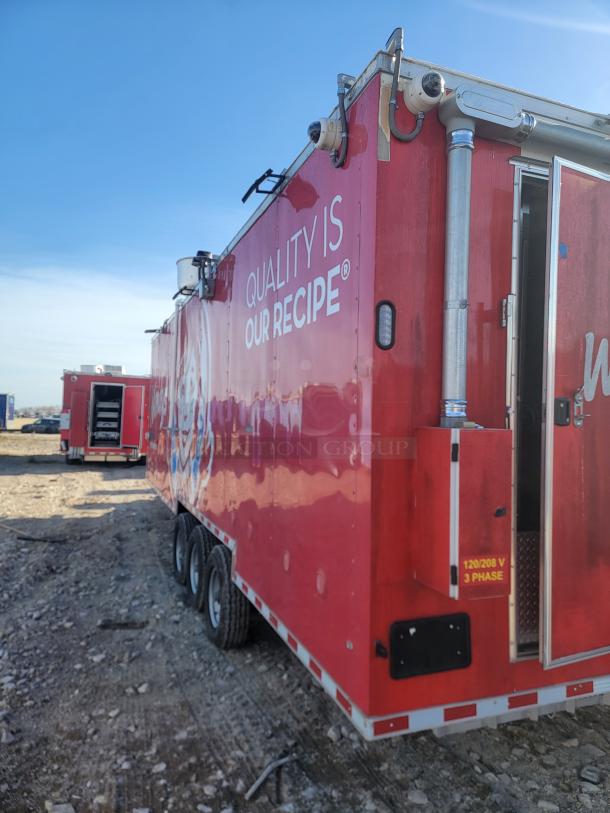 Red food truck with "Quality is Our Recipe" text, featuring three axles, ventilation system, and side service door; marked 120/208 V 3 Phase.